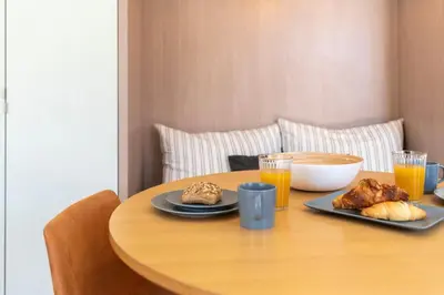 a table with a plate of food and drinks on it at Prime Riverside in Porto