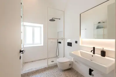 a white bathroom with a sink and a toilet at Prime Riverside in Porto