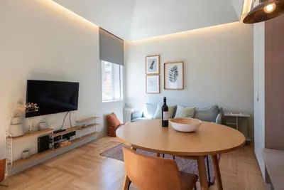 a living room with a table and a couch at Prime Riverside in Porto