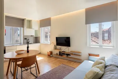 a living room with a table and a tv at Prime Riverside in Porto