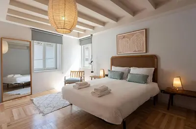a bedroom with a large bed with two towels on it at Prime Riverside Duplex in Porto