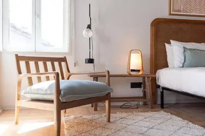 a bedroom with a bed and a chair and a desk at Prime Riverside Duplex in Porto