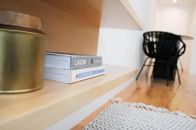 two books sitting on a shelf in a room at Oporto Garden's Home in Porto