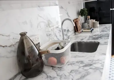 a kitchen counter with a sink with a basket on it at Oporto Garden's Home in Porto
