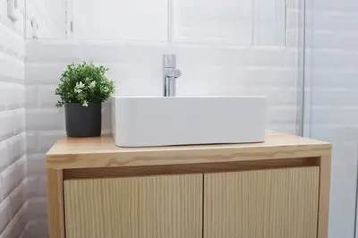 a white sink on top of a wooden vanity in a bathroom at Oporto Garden's Home in Porto