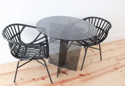a glass table and two chairs on a wooden floor at Oporto Garden's Home in Porto