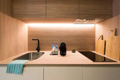 a kitchen with a sink and a counter with a light at Ribeira Old Town Charming Flat w/ AC by LovelyStay in Porto