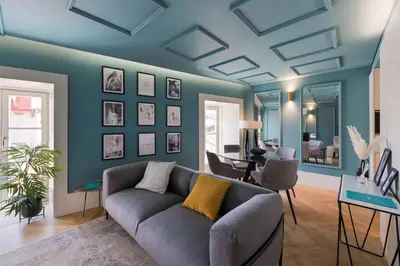 a living room with blue walls and a couch at Ribeira Old Town Charming Flat w/ AC by LovelyStay in Porto