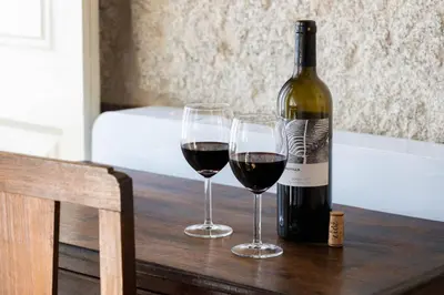 two glasses of wine on a table with a bottle of wine at Uba - Heritage and Wine in Porto