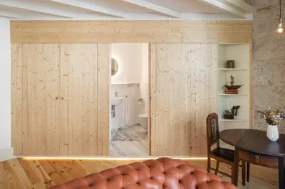 a room with a large wooden sliding door at Uba - Heritage and Wine in Porto