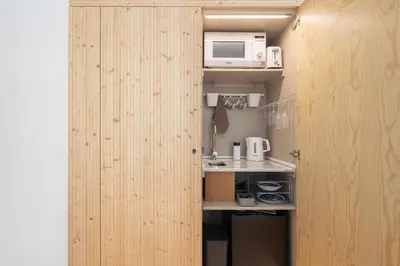 a room with a kitchen with a microwave and a counter at Uba - Heritage and Wine in Porto