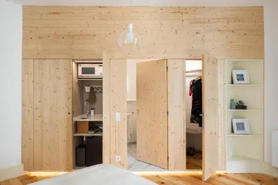 a room with wooden walls and ajar doors at Uba - Heritage and Wine in Porto
