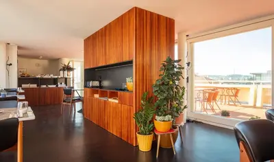 a living room with a large wooden cabinet and some plants at Ceuta Terrace Suites in Porto