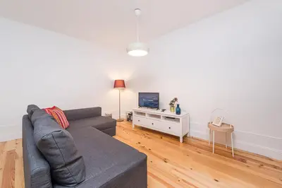 a living room with a couch and a tv at GuestReady - Triple C's in Porto