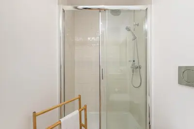 a shower with a glass door in a bathroom at GuestReady - Triple C's in Porto