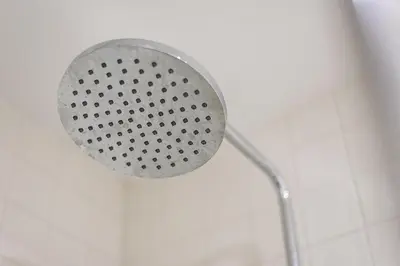a shower with a shower head in a bathroom at GuestReady - Triple C's in Porto