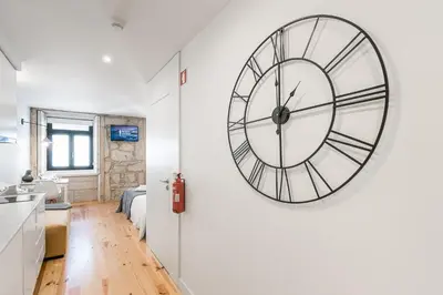 a large clock on a wall in a room at GuestReady - Private oasis for two in Porto