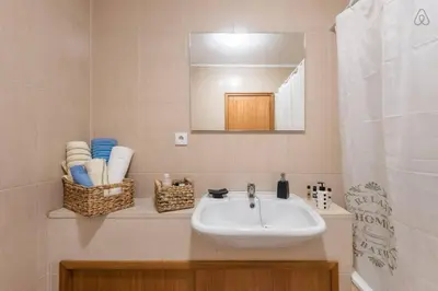 a bathroom with a sink and a mirror at Gaia House - Apartamento com Metro à Porta e Centro Histórico Perto in Vila Nova de Gaia