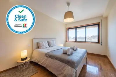 a bedroom with a bed and a sign that says clean and safe at Gaia House - Apartamento com Metro à Porta e Centro Histórico Perto in Vila Nova de Gaia