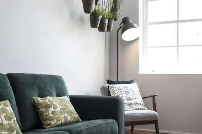 a living room with a green couch and a chair at Sta Catarina - 2 Bedroom Apartament in Porto
