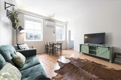 a living room with a couch and a flat screen tv at Sta Catarina - 2 Bedroom Apartament in Porto