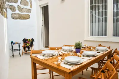 a dining room with a wooden table and chairs at Apartamentos Portodouro - Santa Catarina in Porto