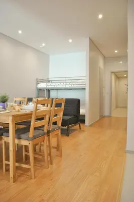 a dining room with a wooden table and chairs at Apartamentos Portodouro - Santa Catarina in Porto