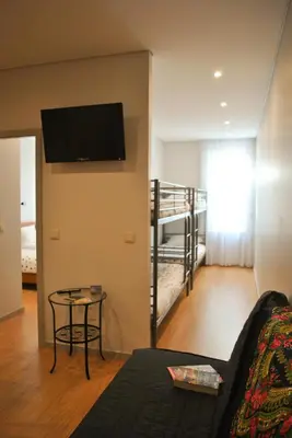 a living room with a couch and a bunk bed at Apartamentos Portodouro - Santa Catarina in Porto