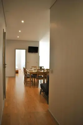 a dining room with a table and a dining roomiasm at Apartamentos Portodouro - Santa Catarina in Porto