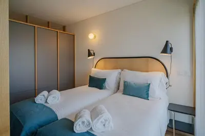 a kitchen and dining room with a table and a refrigerator at Feel Porto Corporate Housing Campanhã in Porto