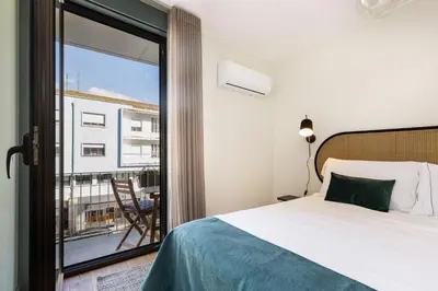 a living room with a couch and a table at Feel Porto Corporate Housing Campanhã in Porto