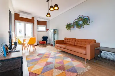 a living room with a couch and a table at Camões Loft in Porto