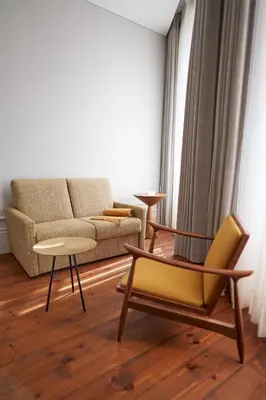a living room with a couch and a table and chairs at Rio da Vila in Porto