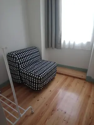 a chair in an empty room with a window at Near River 63 in Vila Nova de Gaia
