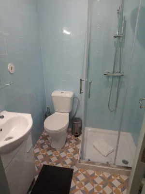 a bathroom with a shower and a toilet and a sink at Near River 63 in Vila Nova de Gaia