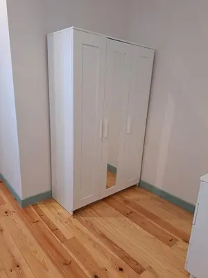a white cabinet in a room with a wooden floor at Near River 63 in Vila Nova de Gaia