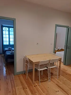 a dining room with a wooden table and chairs at Near River 63 in Vila Nova de Gaia