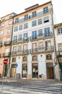 a large building with balconies on the side of a street at Infante Douro View in Porto