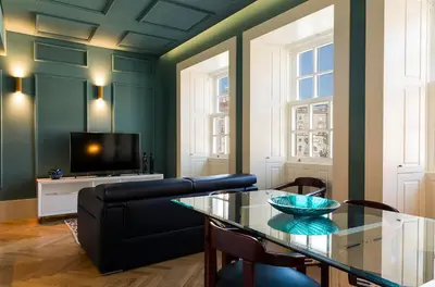 a living room with a glass table and a couch at Infante Douro View in Porto