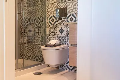 a bathroom with a toilet and a shower at Casa Nina in Porto