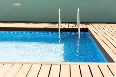 a swimming pool with two poles in the water at Casa Nina in Porto