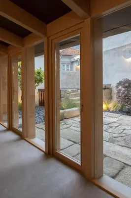 a room with sliding glass doors in a house at Na Travessa Suítes in Porto