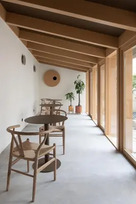 a room with tables and chairs and windows at Na Travessa Suítes in Porto