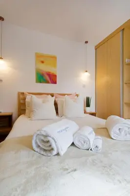 a bedroom with two white towels on a bed at Miragaia Rio in Porto