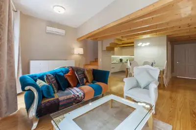 a living room with a couch and a glass table at GuestReady - Beige Glamour in Porto