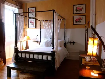 a bedroom with a four poster bed and a window at VIVA Fabulous Old World in Porto