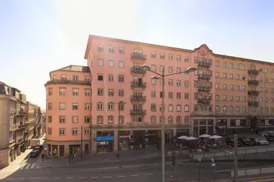 a large pink building on a city street at VIVA Fabulous Old World in Porto