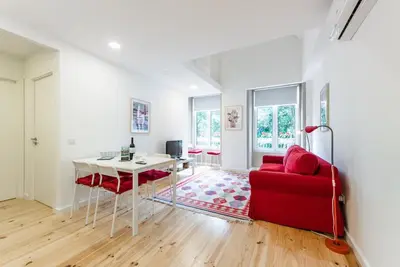 a living room with a red couch and a table at GuestReady - Belas Artes Duplex in Porto