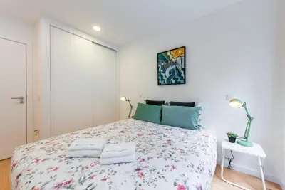 a white bedroom with a large bed with two pillows at GuestReady - Belas Artes Duplex in Porto