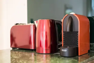 two coffee pots and a toaster on a counter at GuestReady - Belas Artes Duplex in Porto